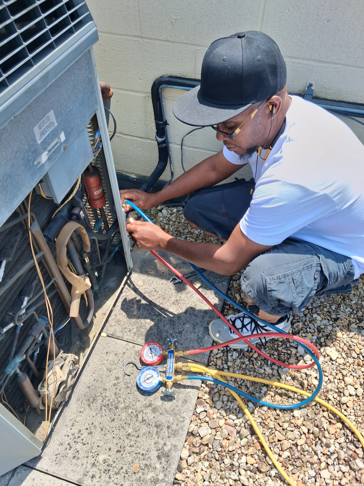 Its Phenomenal Air HVAC technician servicing an air conditioner in Baltimore, MD