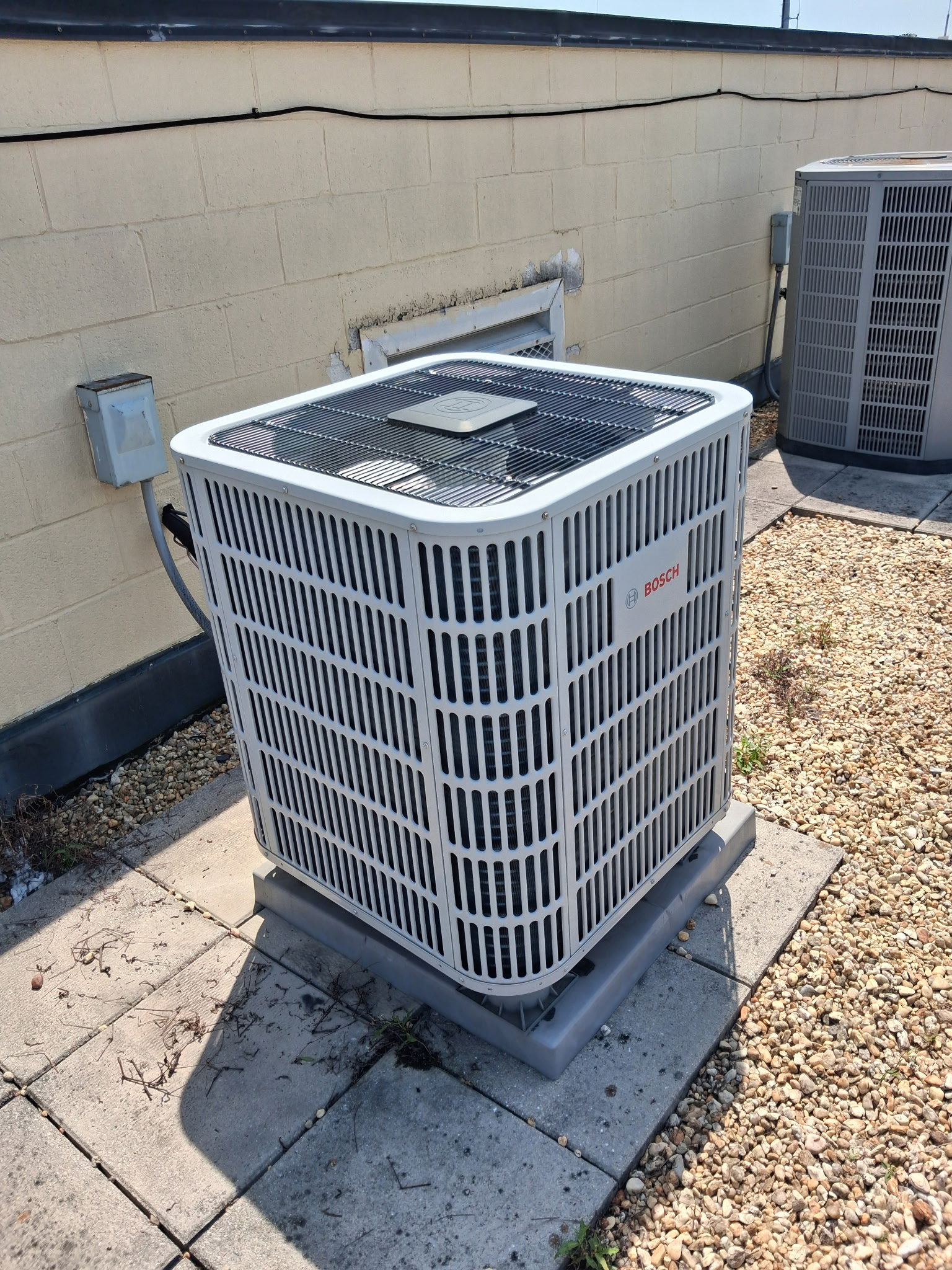 Certified HVAC technician repairing a home heating and cooling system in Baltimore, MD